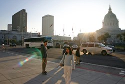 Tab and Tina with the sun setting behind City Hall